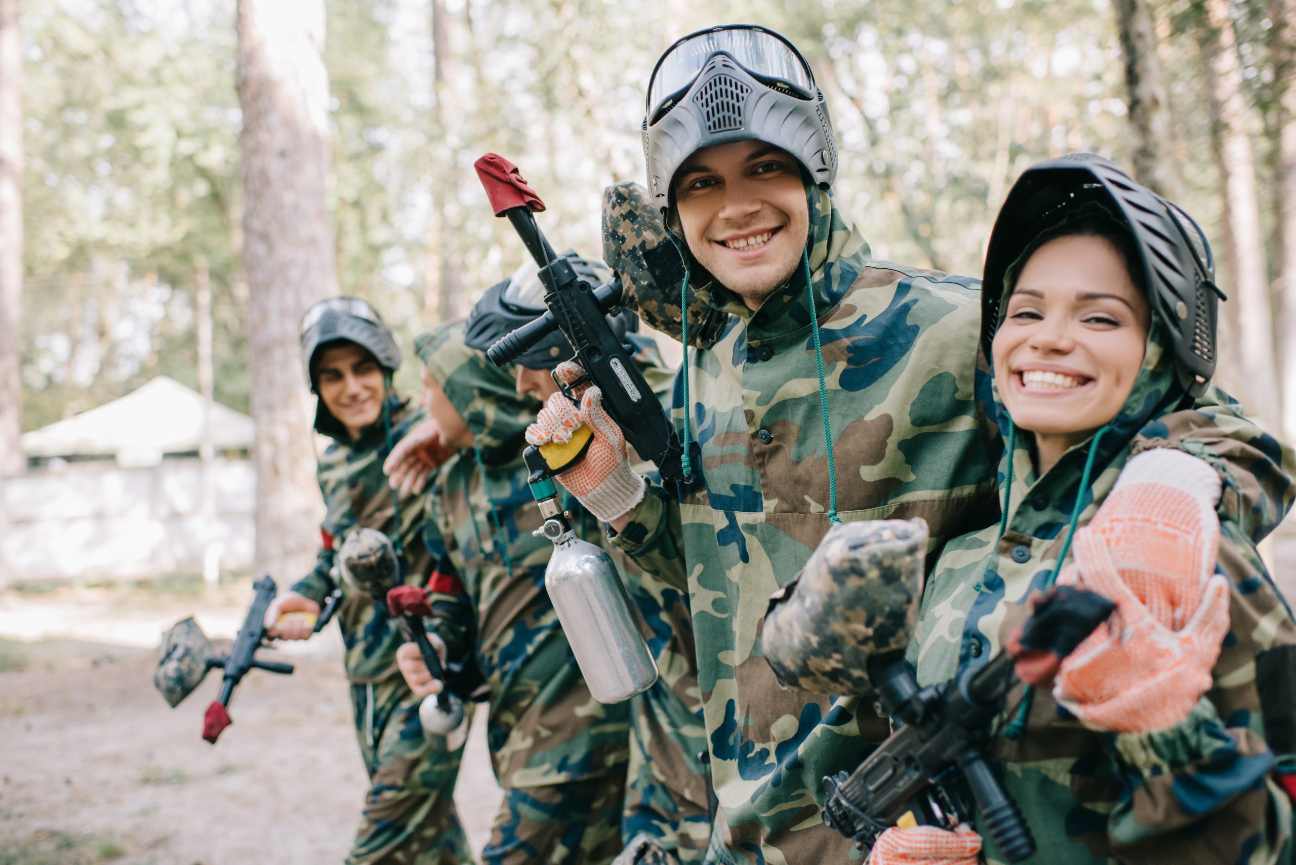 Upskill Now Team Building 8 Upskill Now - smiling young male paintballer embracing female te 2022 12 16 21 18 52 utc scaled